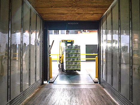 A forklift truck with a fully loaded pallet distributes incoming goods